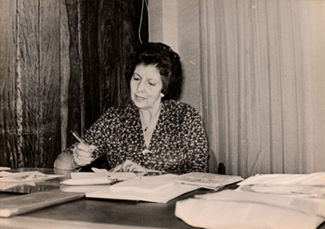 Garnet J. Knights seated at desk, undated