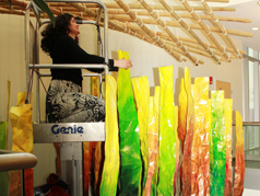 Installation of the mobile took place throughout fall 2012, including cutting, crumpling, sanding, painting and, shown here, hanging pieces high above the atrium floor.