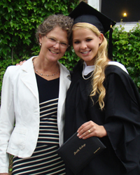 Maurine Miller '13, diploma in hand, with her mother, Lucia, on graduation day.