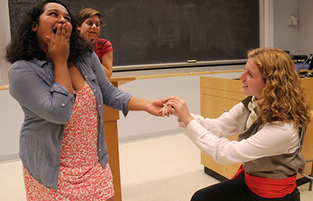 After the Assembly passes a law establishing marriage as a civil matter rather than a spiritual one, Antoine Saint-Just, played by Amanda Miller '17, proposes to Maximillen Robespierre (Mohona Chowdhury '17) as Amanda Emily Rabe '16 officiates.