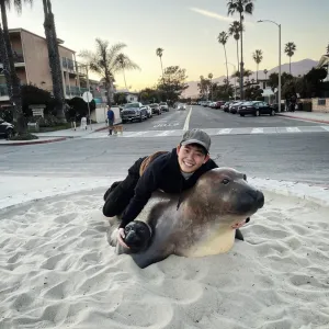 Elie Ziehl '24 on a seal sculpture in the sand