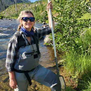 Leah Harries ‘24 standing in waders in a stream