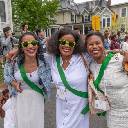 Three alums wearing green sashes on Ivy Day 2023