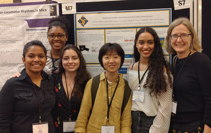 Students and professor at a poster presentation