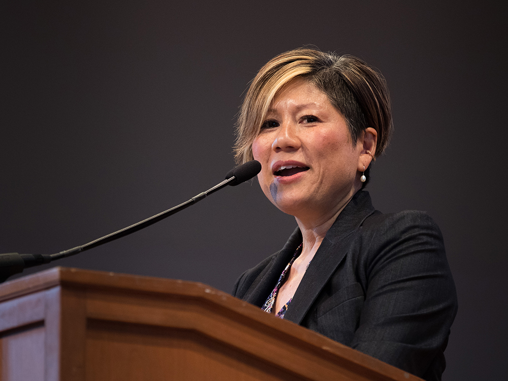 Marianne Yoshioka speaking at a podium