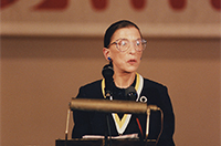 Ruth Bader Ginsburg speaking at a podium on stage