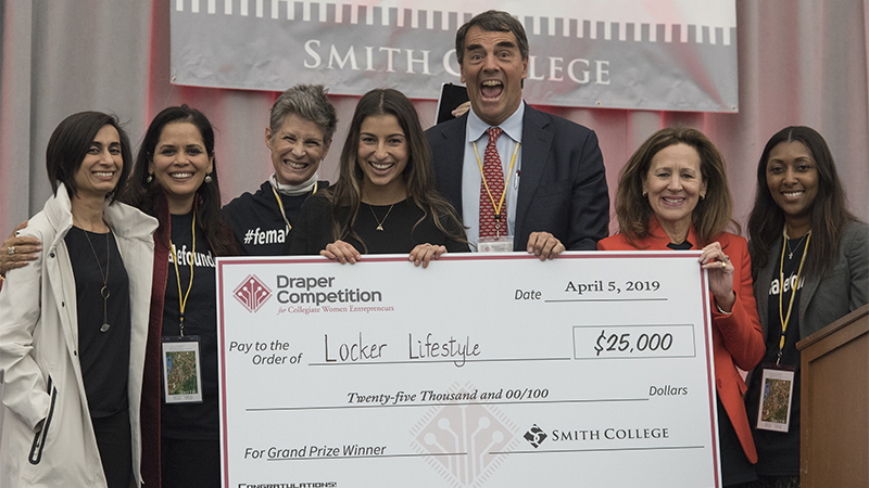 The top prize-winning team at the 2019 Draper Competition holding a check.