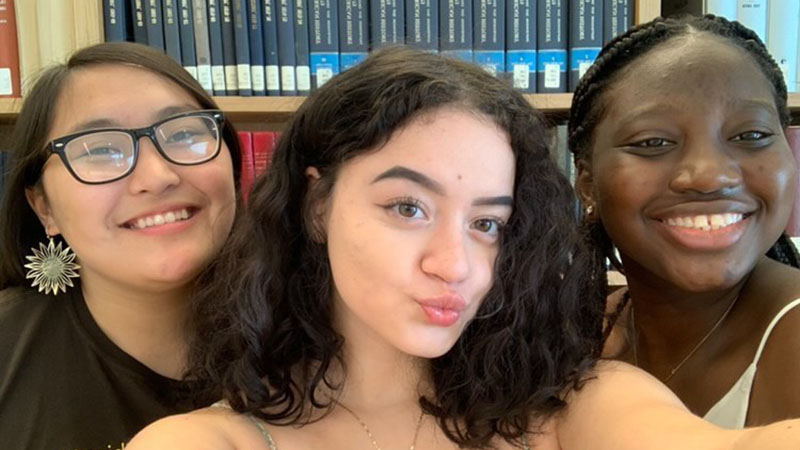 Three high school students close together in a portrait for precollege programs