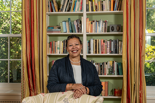Sarah Willie-LeBreton smiling in front of a bookshelf.