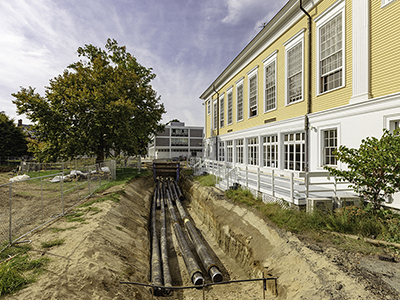 A photo of pipes being laid underground as part of the geothermal energy project on campus.