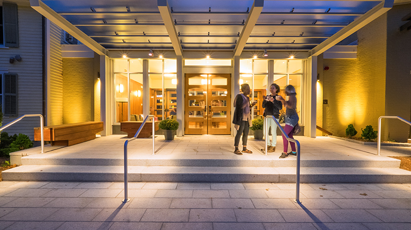 Conference Center entryway at night, with students