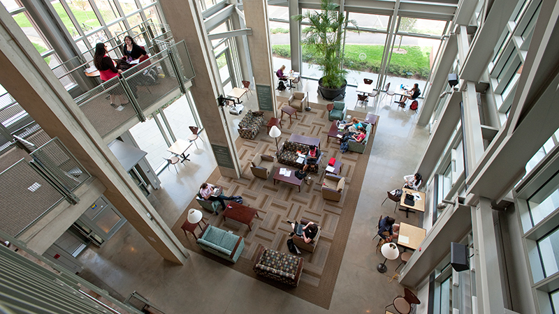 View from above the atrium in Ford Hall with students working in small groups