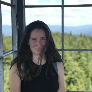 Helen Sher '24 looks at the camera in front of a window