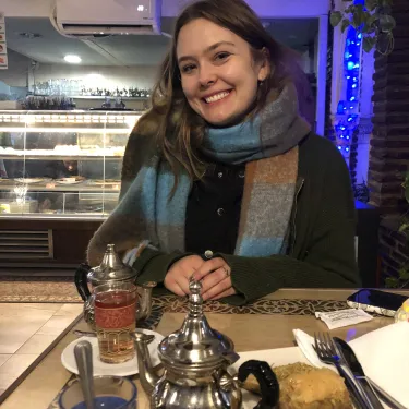 Elizabeth Peters ‘24 smiles, seated with a tea set