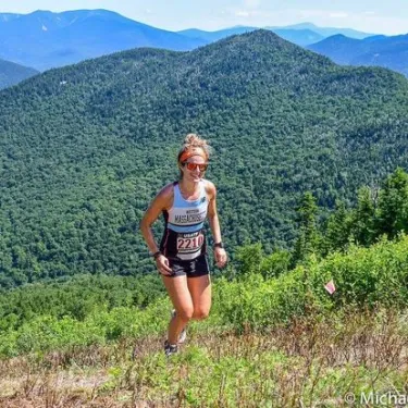 Rachel Cook running up a mountain.