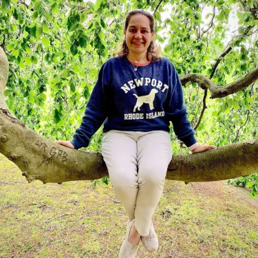 Rebecca Washut sitting on a tree branch