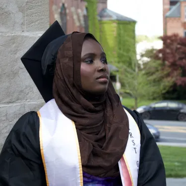 Hamssatou Almahamoudou Maiga ‘24 wearing a black graduation cap and gown