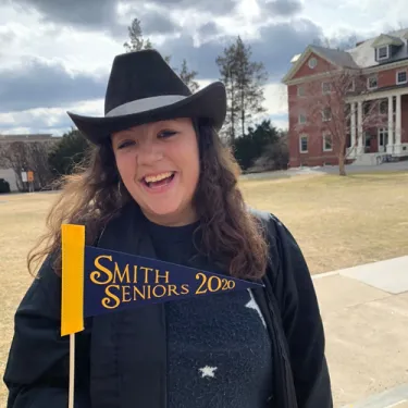 Leah Brand in a cowboy hat with a Smith Seniors 2020 flag
