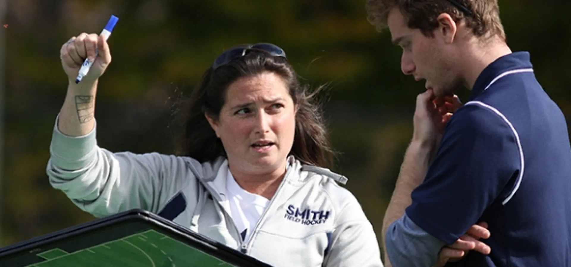 Smith College coaches discuss strategy on the field