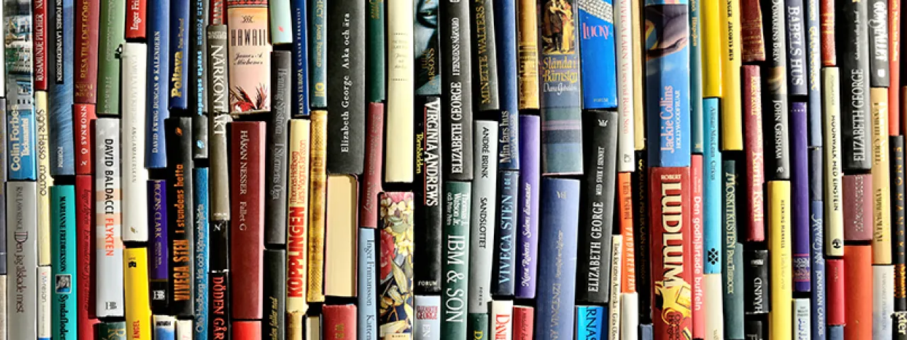 Closeup of a variety of book spines in many colors