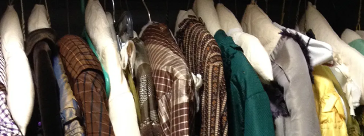 Row of clothes hanging in a closet