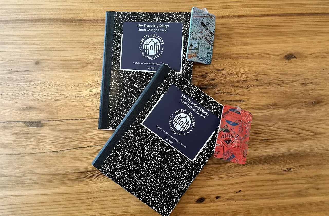 Two journals with "passports" on a wooden tabletop