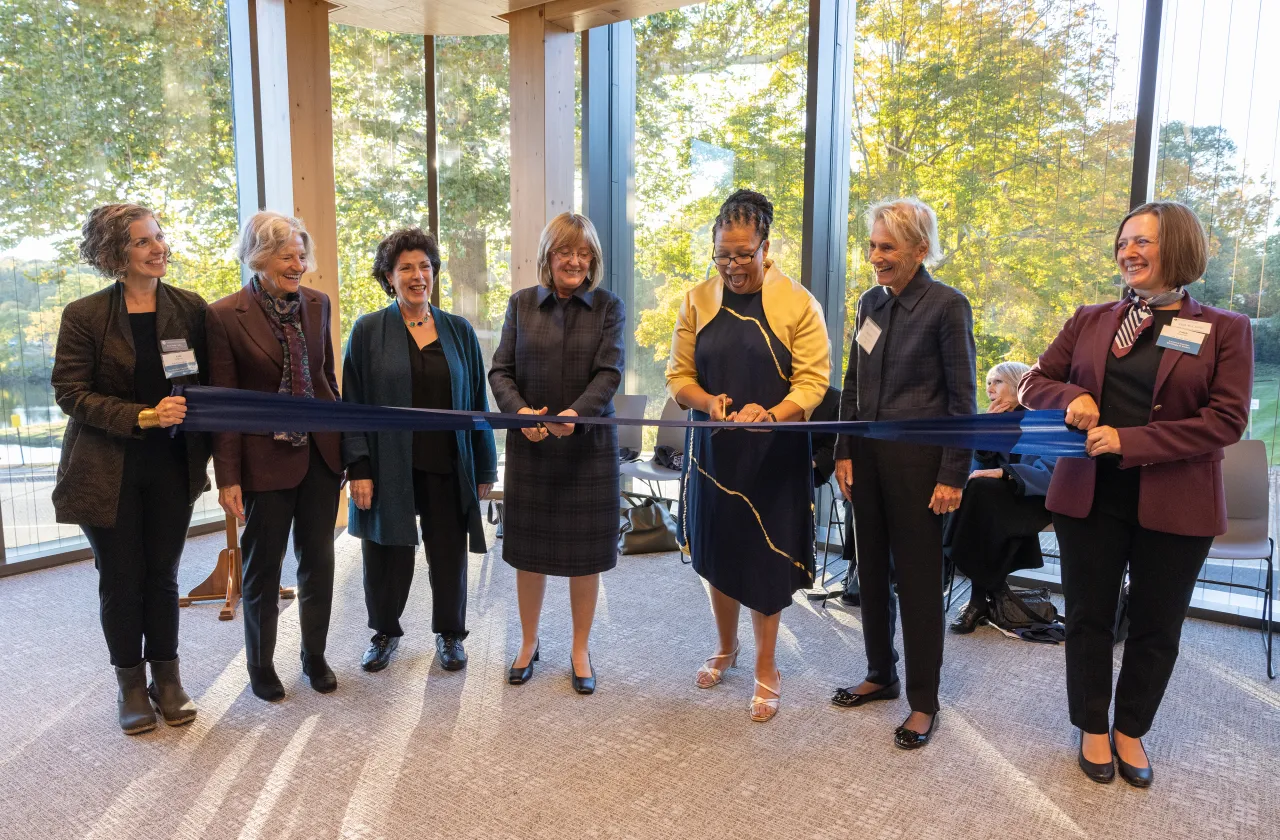Kathleen McCartney and Sarah Willie-LeBreton with members of the Board of Trustees, cutting the ribbon at Kathleen McCartney Hall.