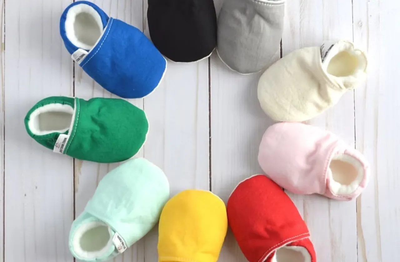 A collection of colored baby shoes arranged in a circle
