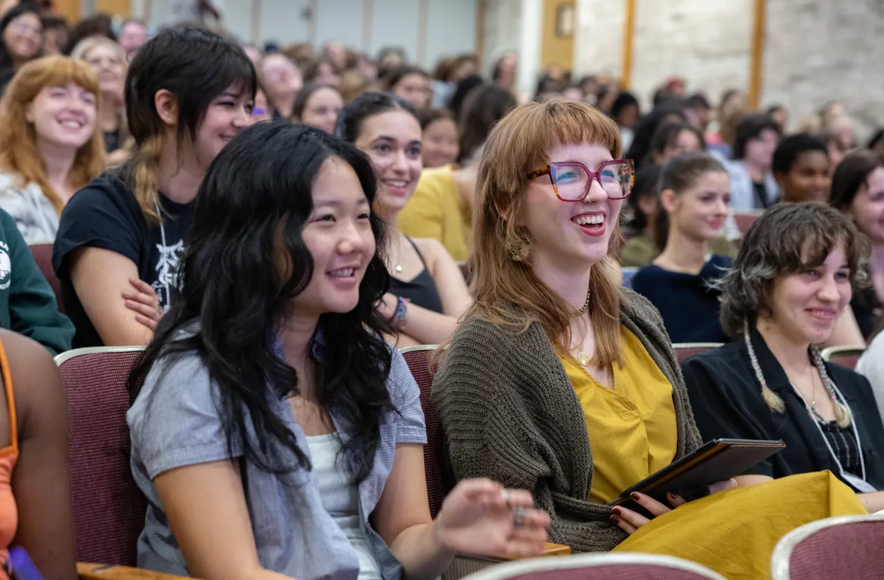 Students laugh in a lecture hall