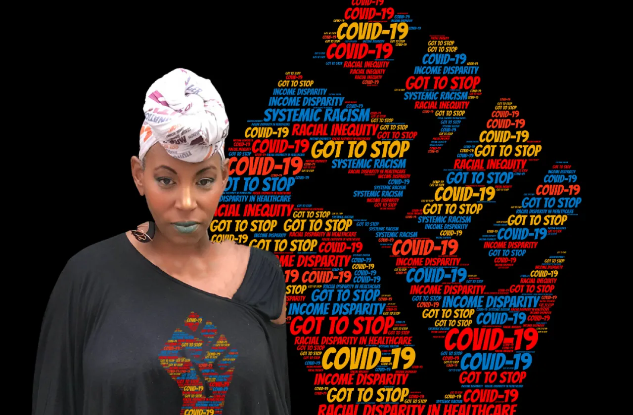 Erika Ewing standing in front of a black power fist assembled from a covid-19 wordcloud. She is wearing a shirt with the same image.