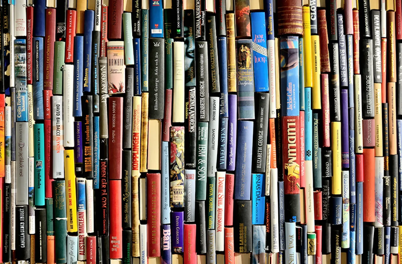 Closeup of a variety of book spines in many colors