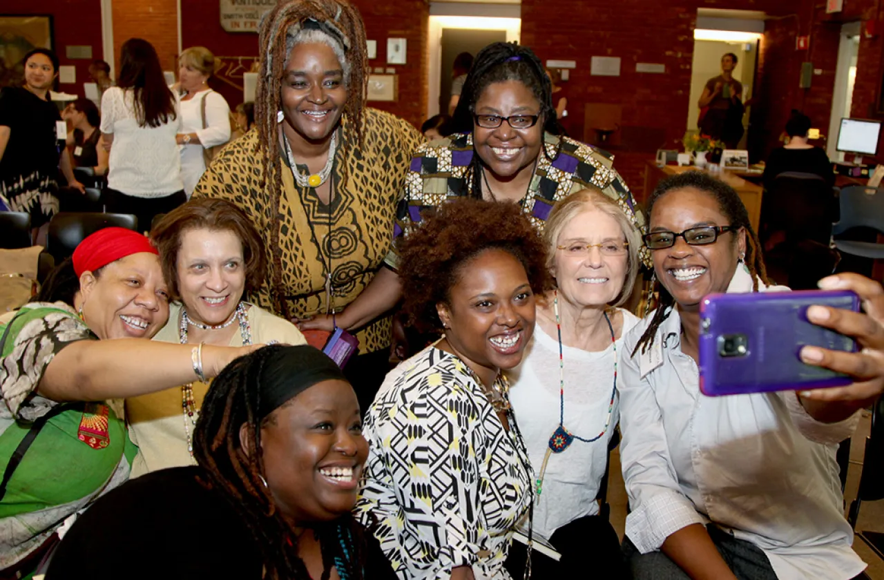 Gloria Steinem takes a selfie with a group of Gloria and Wilma School students