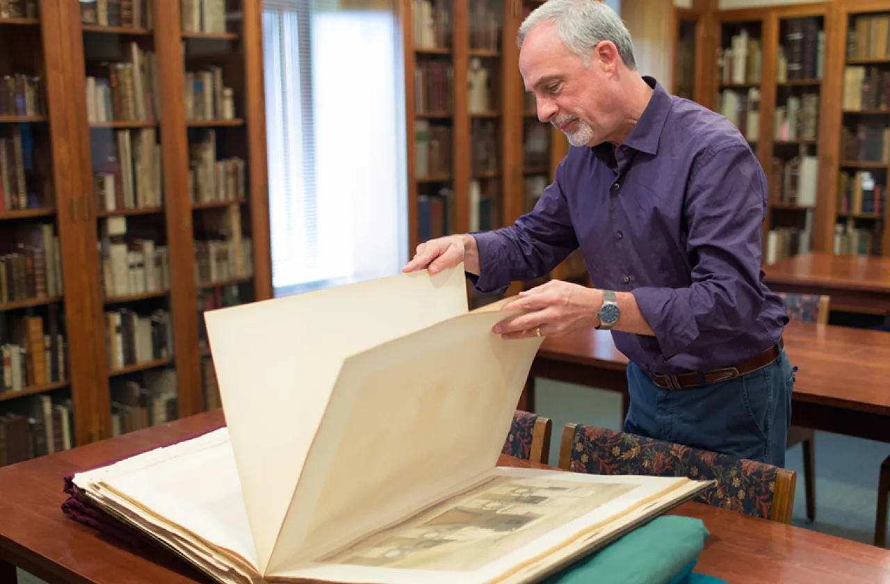 Martin Antonetti, curator of rare books at Smith, displays one of seven volumes of "The Holy Land," a rare set of volumes an alumna recently gave to the collection.