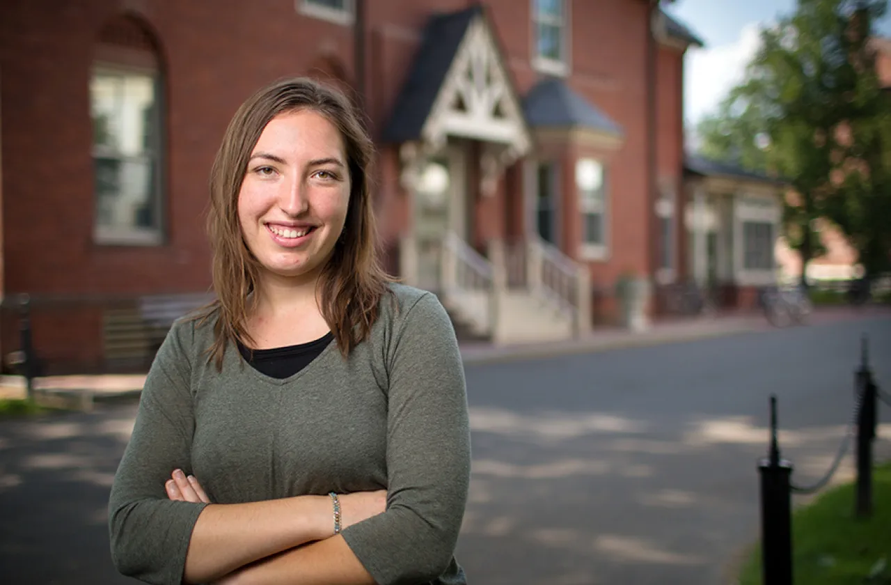 Angelica Radke '18 stands in front of Hatfield Hall, where she first took Smith classes as a senior in high school.