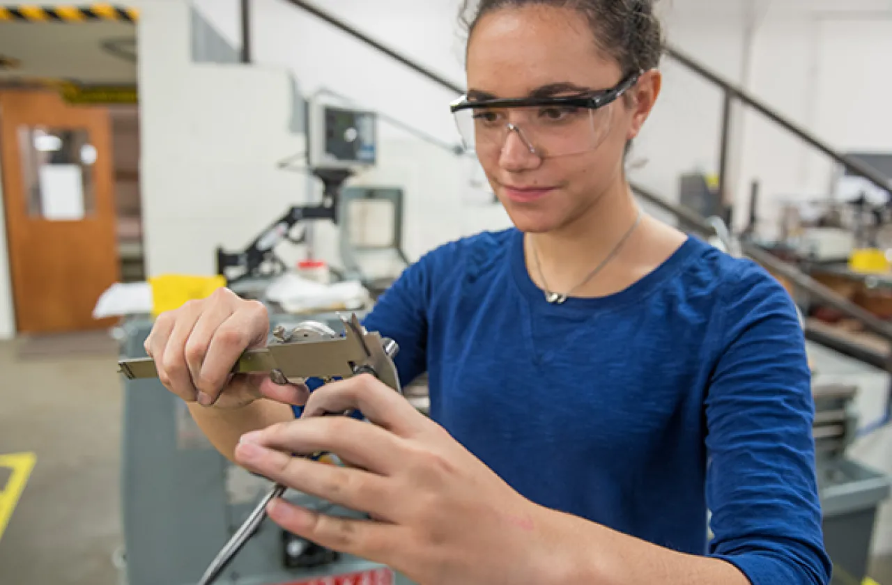 Photo of a student working in design and fabrication