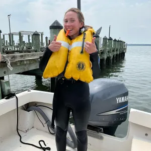 Seychelle Brainard in a wetsuit and life preserver during her internship with NOAA.