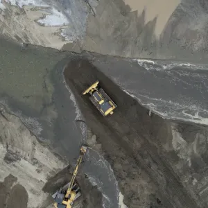 Drone image of Paradise Pond work with a yellow bulldozer and excavator moving silt
