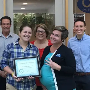 Members of the Office of Student Engagement display their sustainability certificate