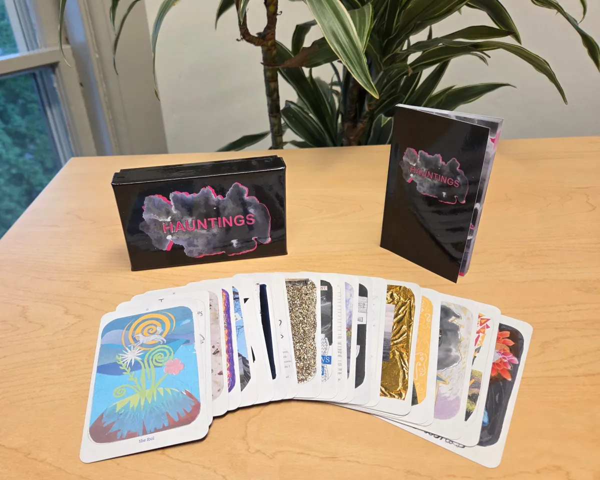 The tarot deck laid out on a table, with The Fool card on top of the pile.