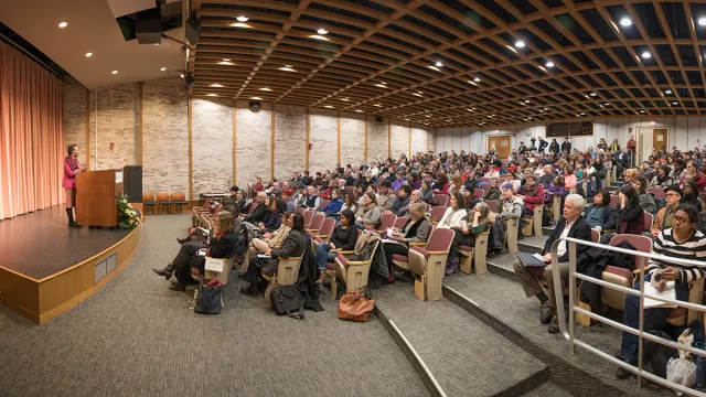 Claudia Rankine reading to an audience in Weinstein Auditorium