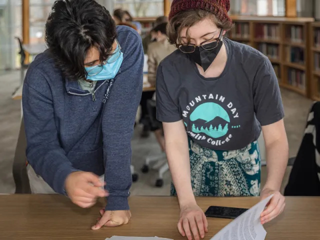Fiona King and another student looking at archival materials