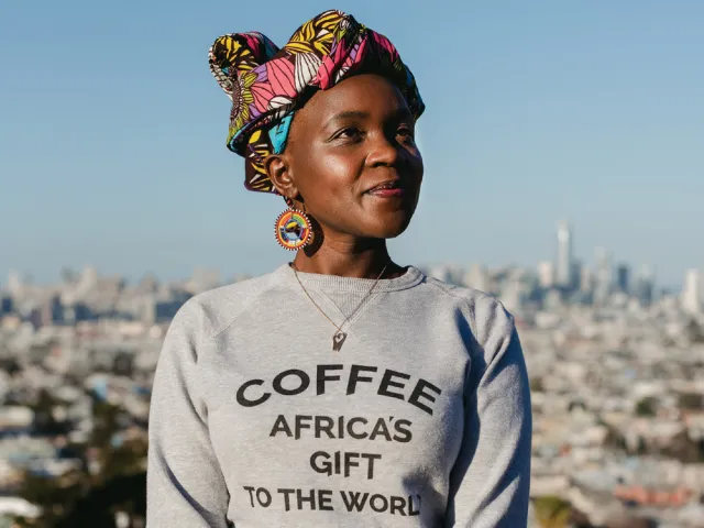 Margaret Nyamumbo wearing a sweatshirt with the slogan "Coffee: Africa's Gift to the World"