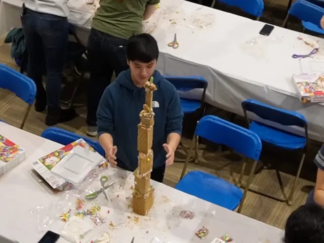 An engineering student building a gingerbread skyscrapers