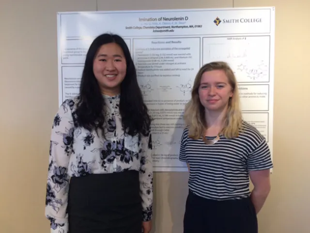 Cindy Hu ’19 and Grace Mills ’19 with the poster they created showing the results of their experiment with neurolenin D.