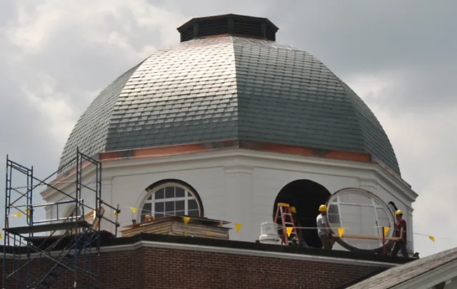 Workers replace windows in Sage Hall