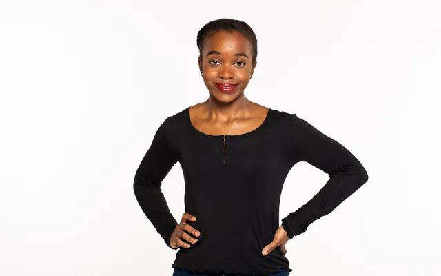 Patience Kayira poses in front of a studio background