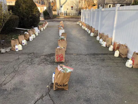 Paper grocery bags filled with food set several feet apart