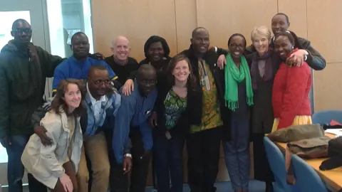 Smith School for Social Work Professor Josh Miller (3rd from left, back row) poses with community leaders from Africa and program administrators during a training on campus.