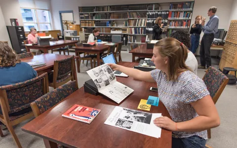 Students working with Smith special collections materials on tables in Young Library