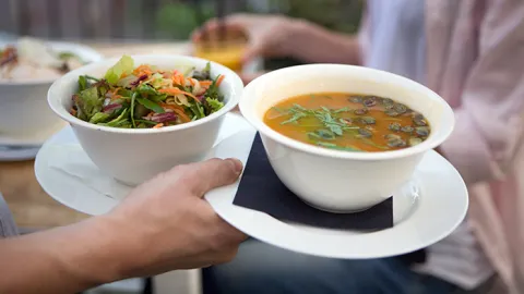 Soup and Salad being carried in bowls